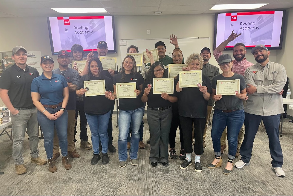 Roofing Academy Graduates standing with their teachers