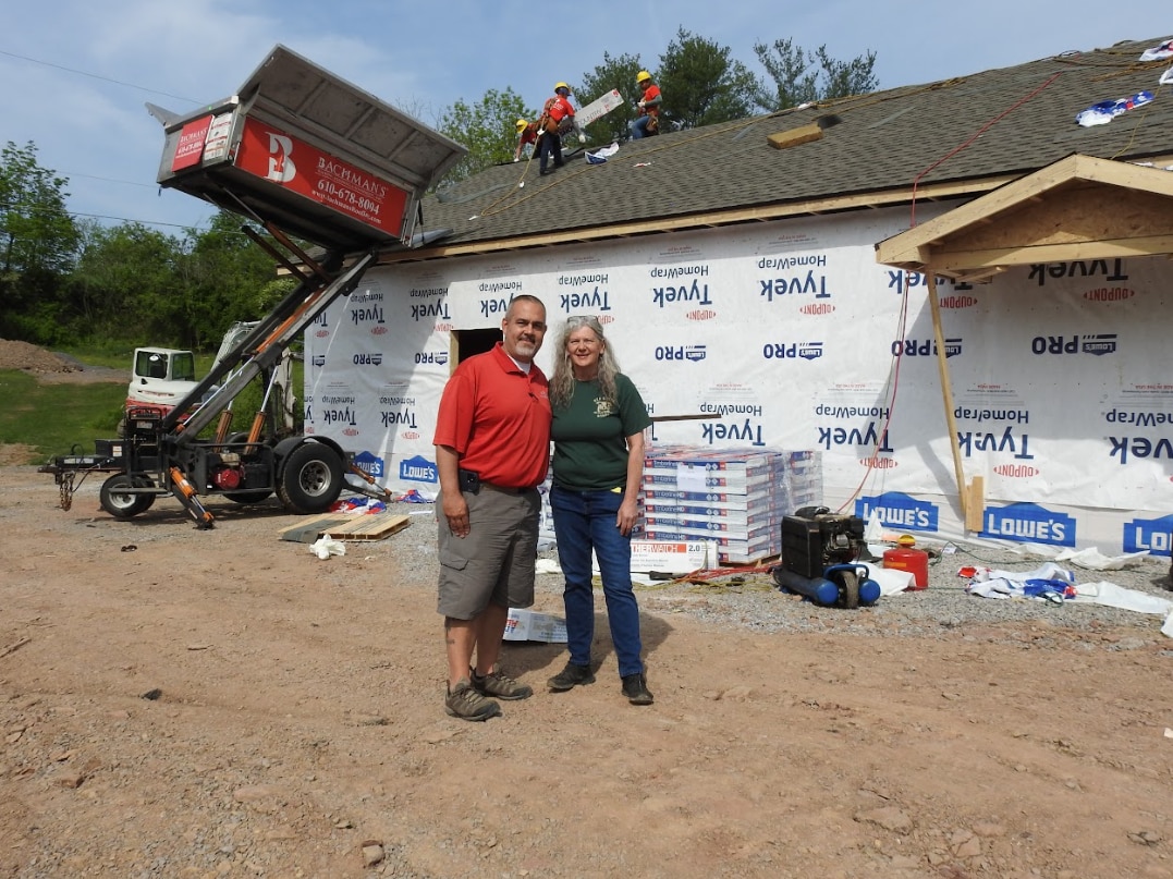 Team members from the wildlife center recovery efforts pose in front of the new building