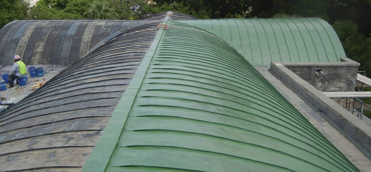 Alamo roof being restored with GAF roof coatings, showing old and new side-by-side