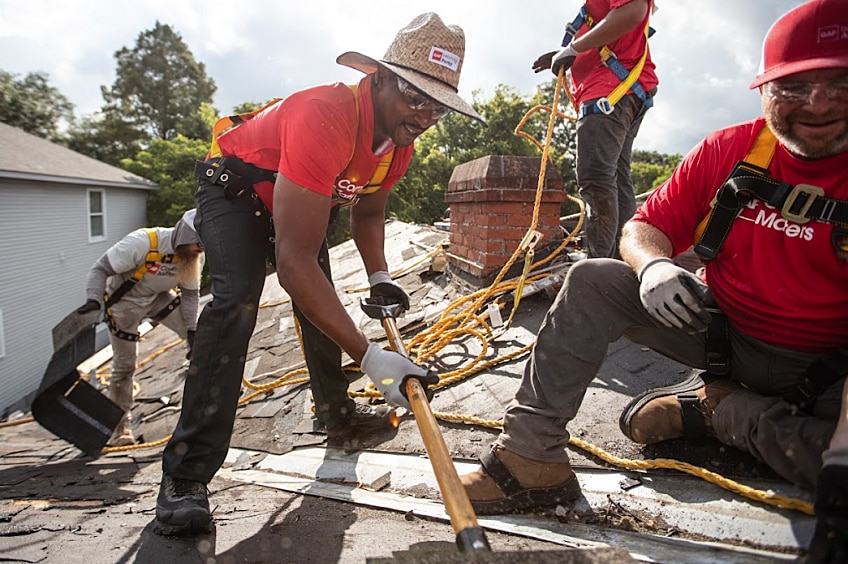 Actor Anthony Mackie demonstrates nailing in a roofing shingle for a GAF Roofing Academy class.