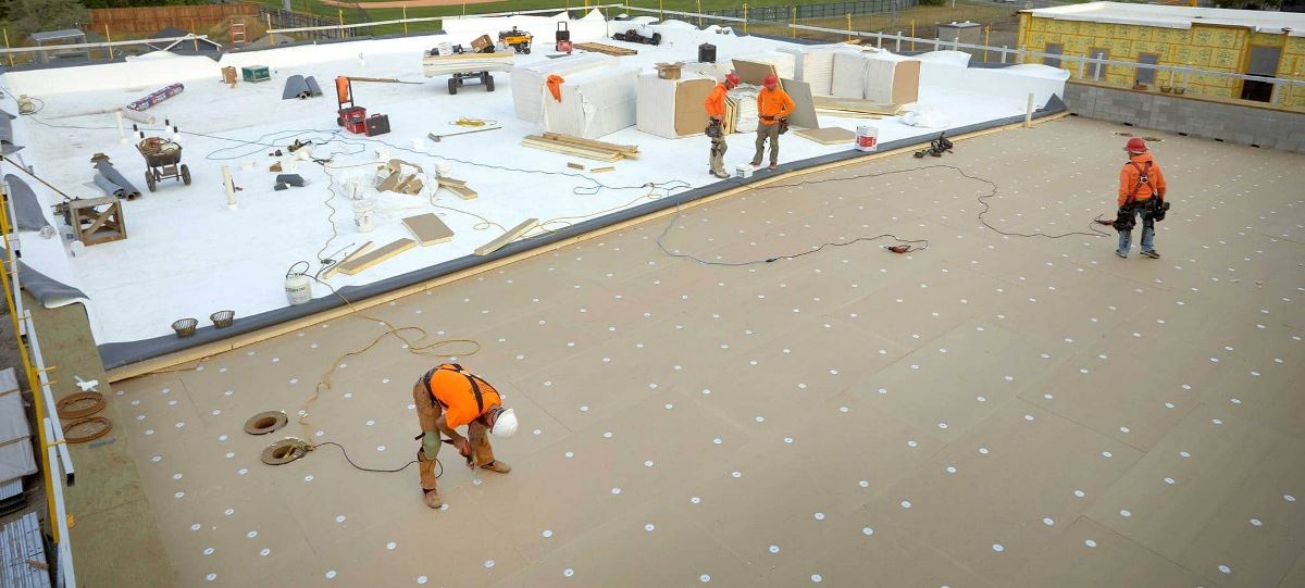 GAF contractors fastening a new TPO roof system on the Bozeman Public Safety Center