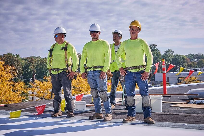 Construction workers looking at steel frame building