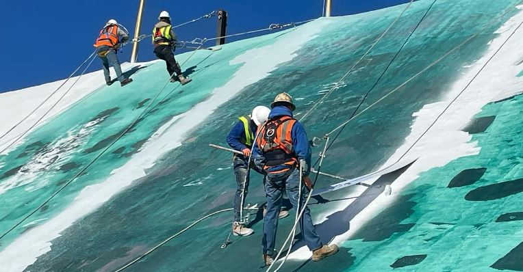 Workers prepping the Circus Circus roof for new GAF coatings