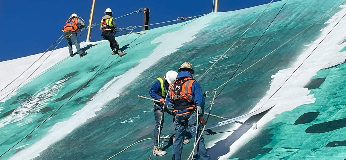 Workers prepping the Circus Circus roof for new GAF coatings