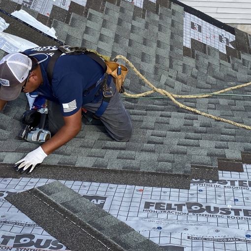 Contractor installing GAF asphalt roof shingles