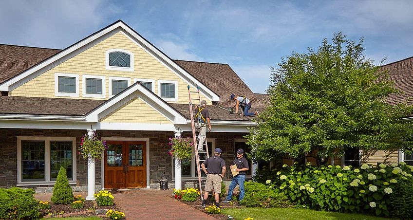 Hands above a small house