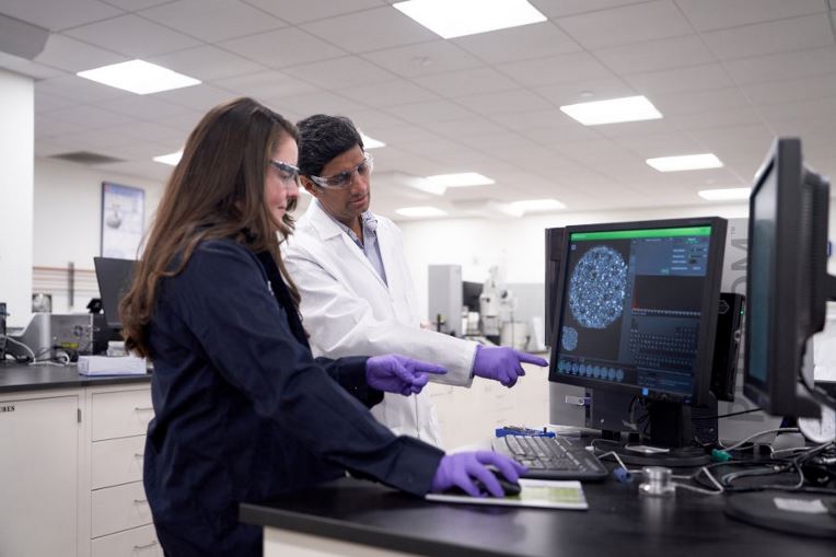 Male and female GAF employees in lab at corporate headquarters