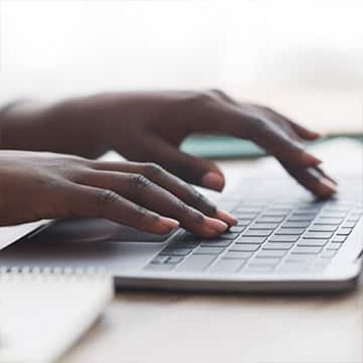 Hands typing on a keyboard