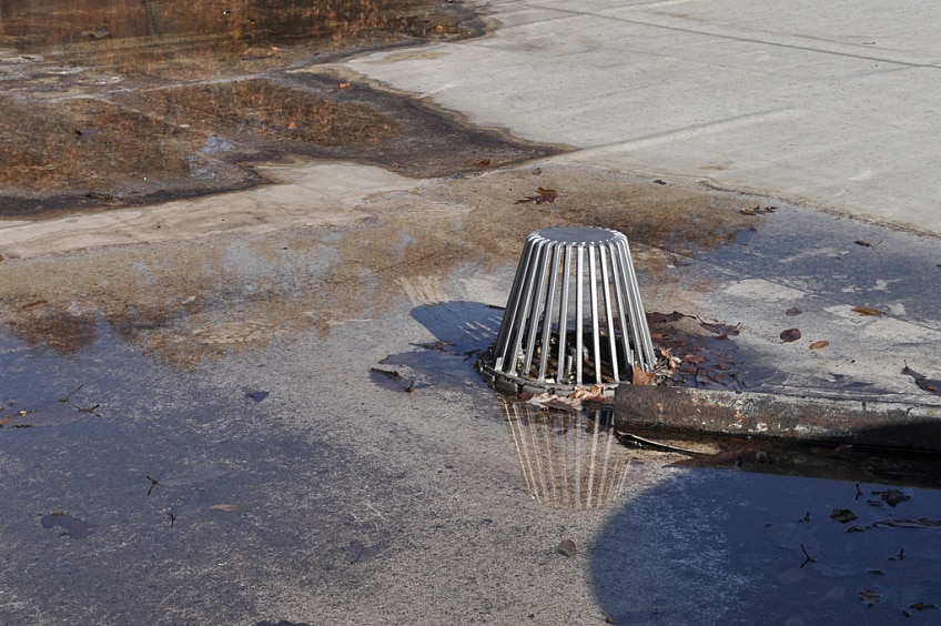 Water flowing from metal downspout