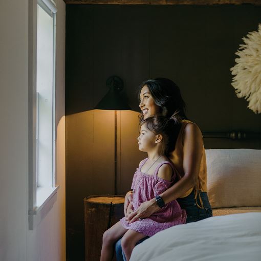 Women and girl looking out window