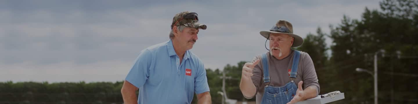 Dave and Wally, GAF's commercial roofing installation experts on top of a flat roof