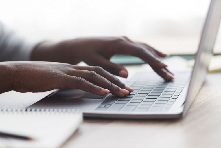 Hands on a laptop keyboard