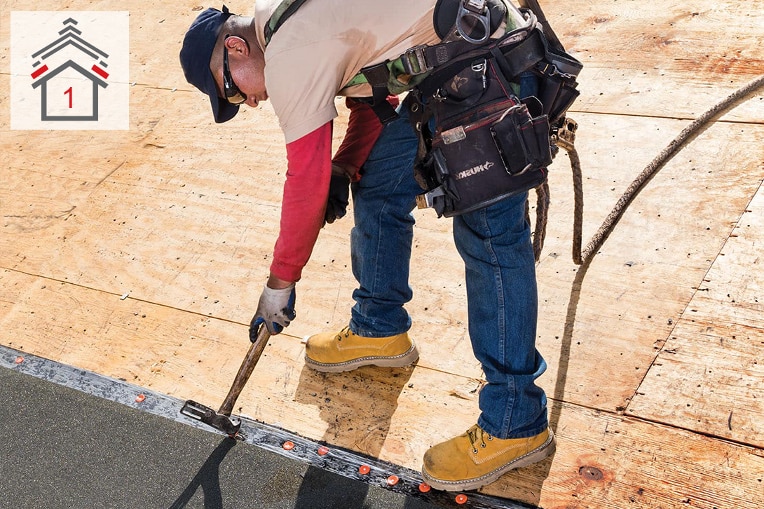 Roofing contractor installing GAF leak barrier 