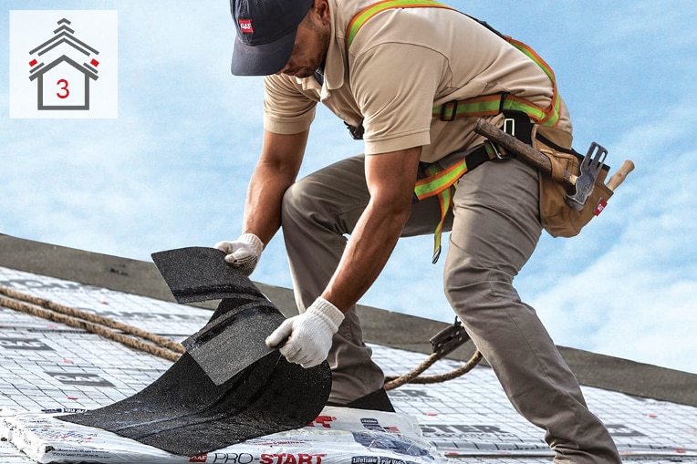 Contractor installing starter strip shingles