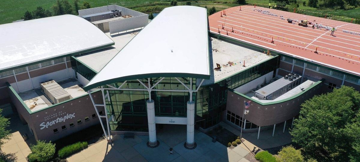 The Orland Park Sportsplex new roof coating in process, with GAF Multi-Purpose Primer on half of the flat roof