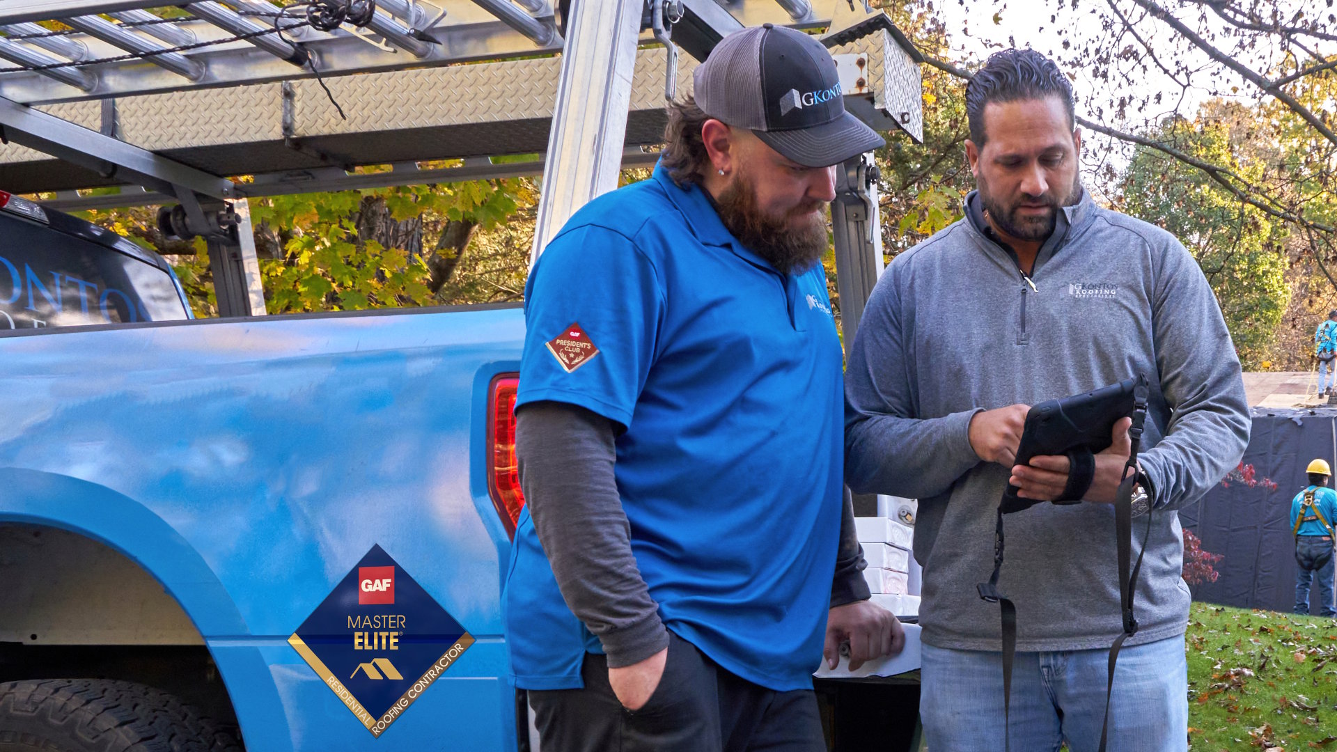 Residential contractors in front of blue truck