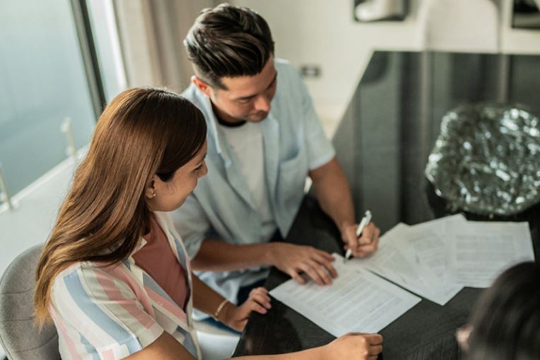 Man and woman reviewing paperwork on table