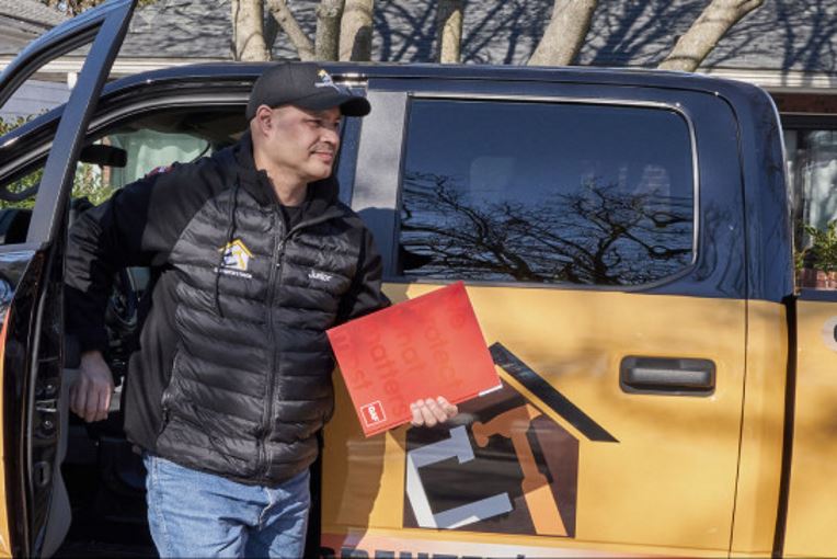 Roofing contractor exiting truck