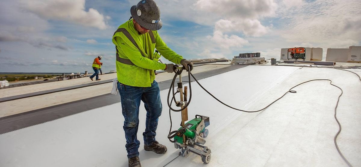 Contractors installing GAF commerical roofing materials on roof