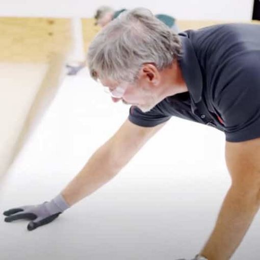 Roofing it Right specialist laying down an commercial roofing membrane