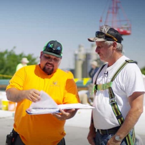 Dave and Wally discussing mod-bit reroof options on top of a flt roof