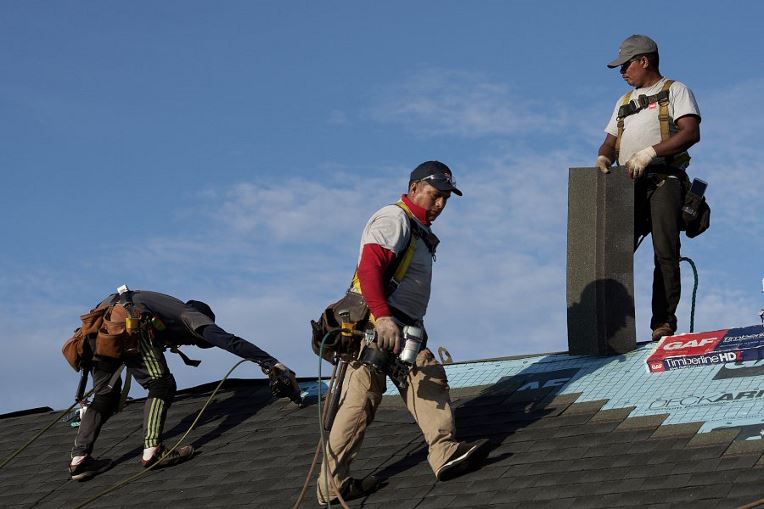 GAF certified contractors installing a new roof in their community