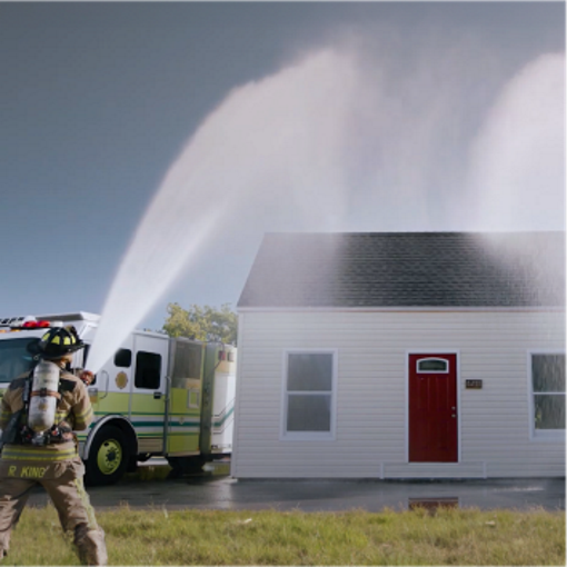 GAF spraying water onto a roof to test its strength.