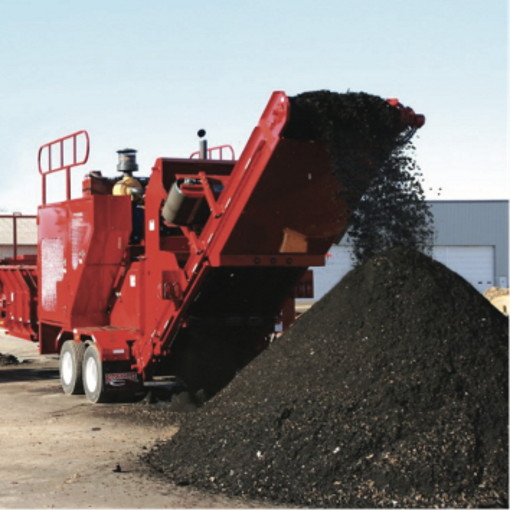 Red GAF machinery recycling old roofing shingles into new shingles.