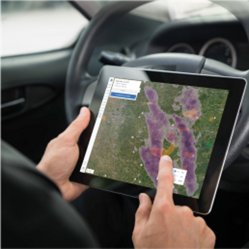 Residential roofing contractor holding tablet open to WeatherHub