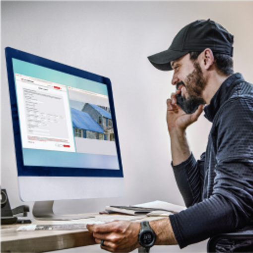 Roofing contractor in front of computer screen